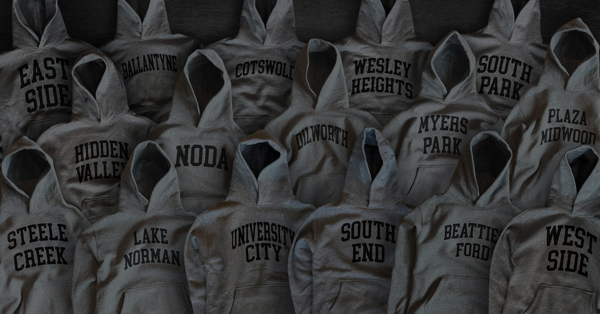 Gray Neighborhoodies printed with Charlotte neighborhood names, including NoDa, South End and Plaza Midwood